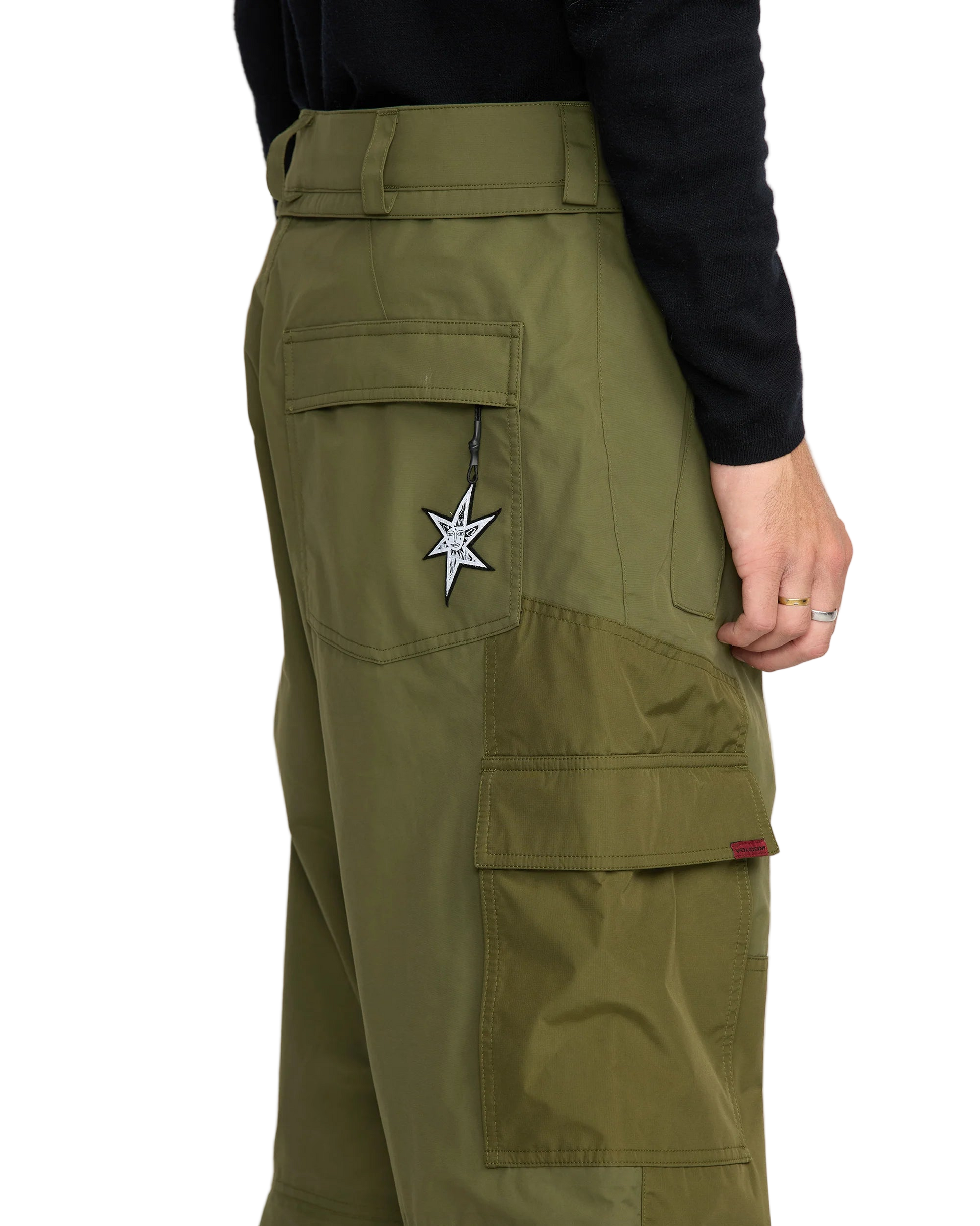 Green cargo pants with a star patch on a white background