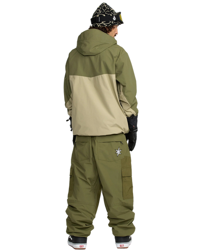 Person wearing the Longo Gore Jacket in green and beige jacket with the Longo Gore Pants in Dark Olive on a white background