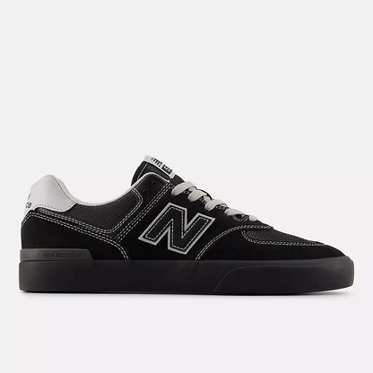 Black sneaker with white accents on a light gray background