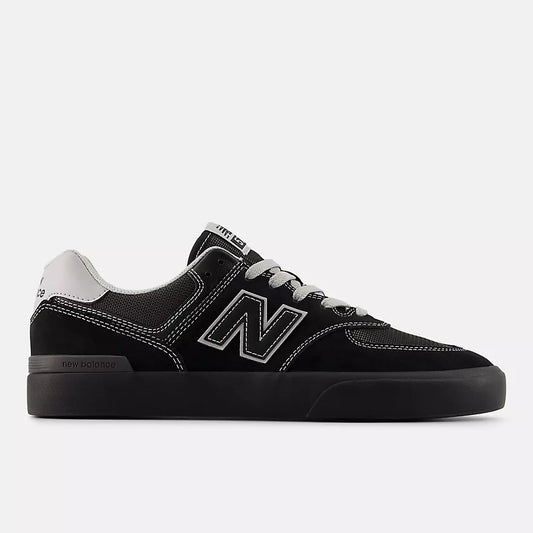 Black sneaker with white accents on a light gray background