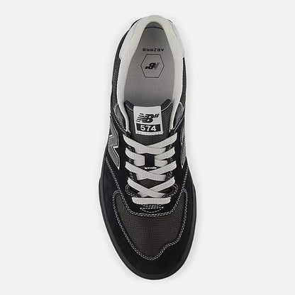 Black sneaker with white laces and New Balance logo on a white background